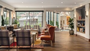 A spacious living area with a large window, multiple seating arrangements, and a central light fixture. - Outbound Sedona (Sedona)