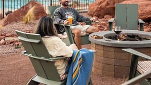 A poolside area with lounge chairs, a fire pit, and a pool. - Outbound Sedona (Sedona)