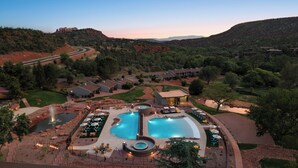 A resort with a large outdoor swimming pool, multiple guest rooms, and a scenic mountain backdrop. - Outbound Sedona (Sedona)