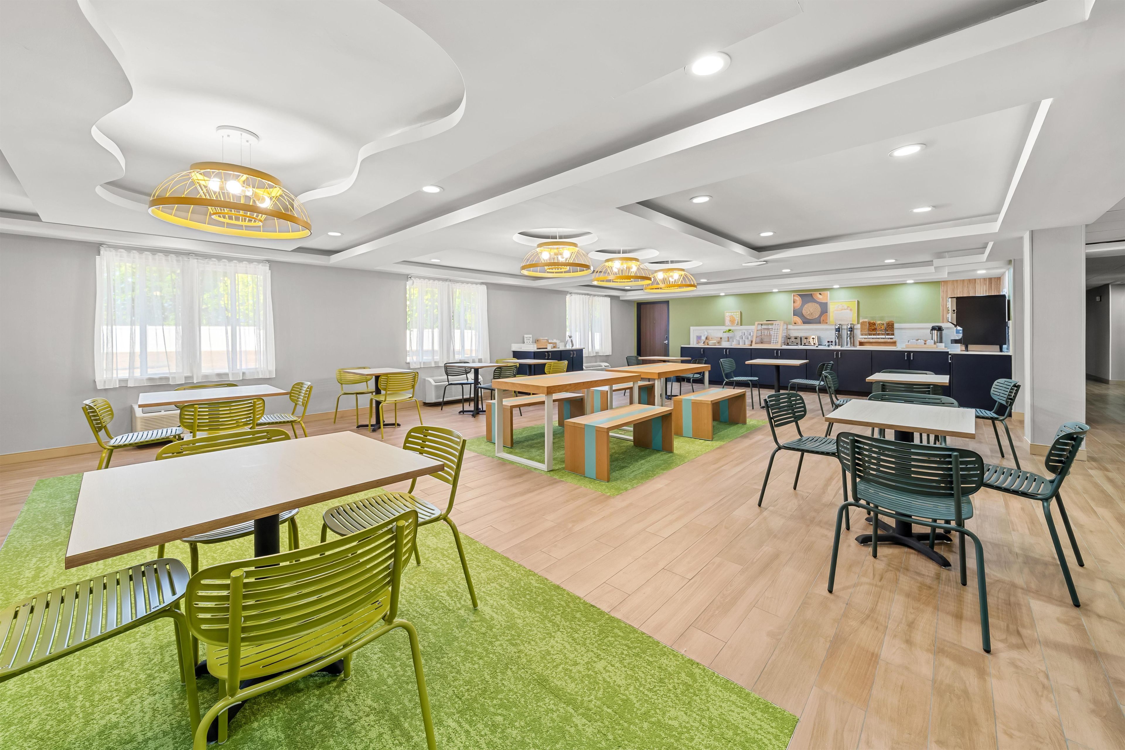 A modern interior with a dining area, kitchen, and seating arrangements.
