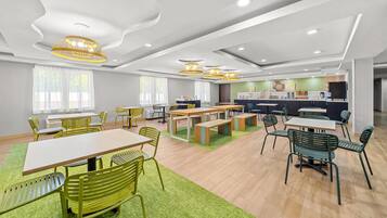 A modern interior with a dining area, kitchen, and seating arrangements.