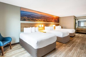 A hotel room with two beds, a desk, a chair, and a large scenic wall mural. - Days Inn by Wyndham Bainbridge (Bainbridge)