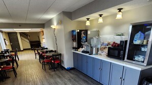 A café with a counter, seating area, and a microwave.