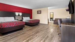 A hotel room with two beds, a desk, a sofa, and a TV. - Econo Lodge Inn & Suites Santa Rosa (Santa Rosa)