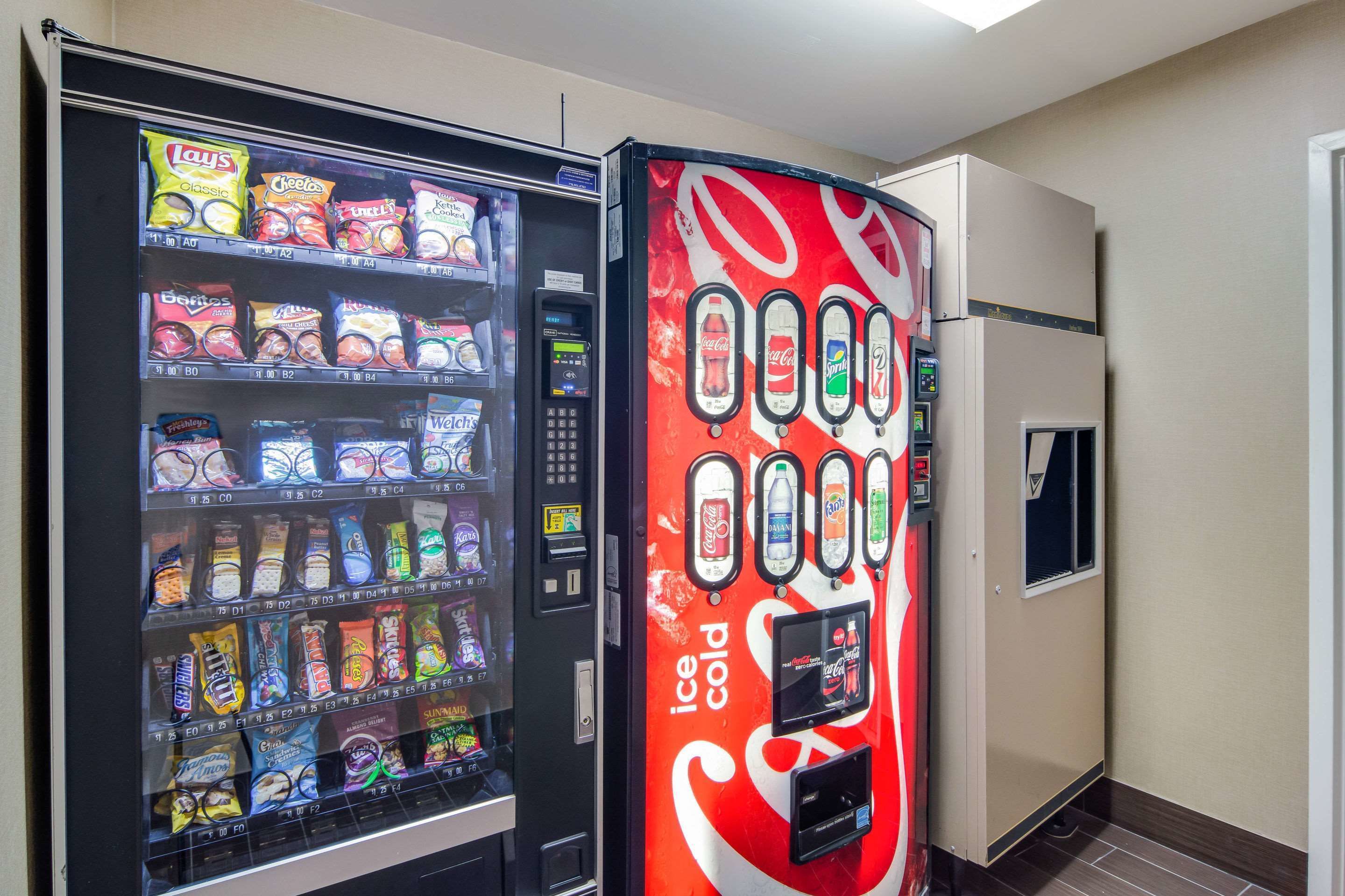 A vending machine with snacks and a Coca-Cola dispenser.