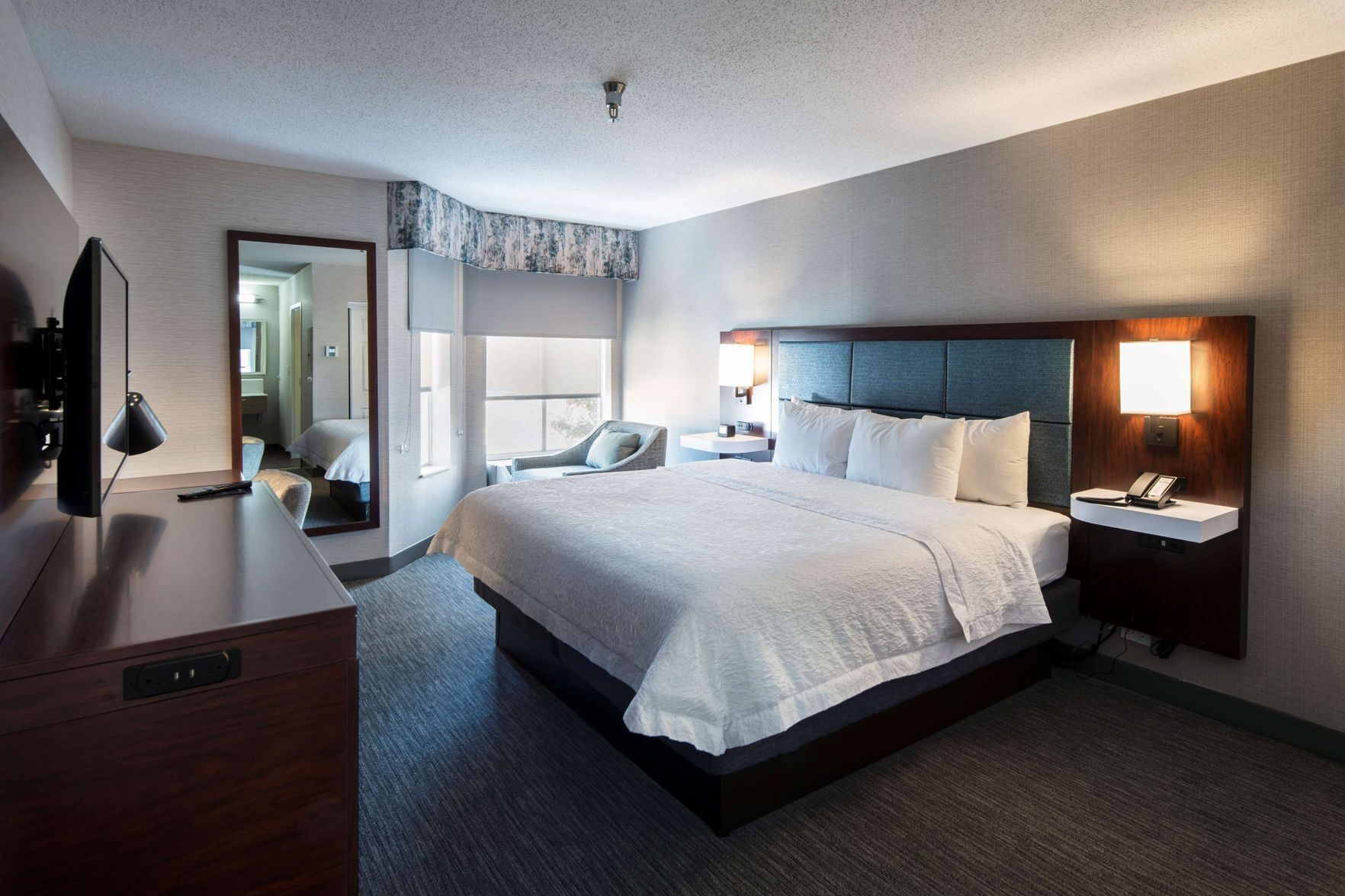 Hypo-allergenic bedding, desk, laptop workspace, blackout curtains