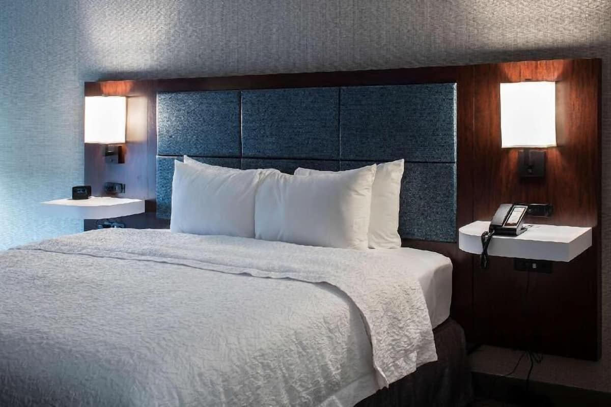 Hypo-allergenic bedding, desk, laptop workspace, blackout drapes