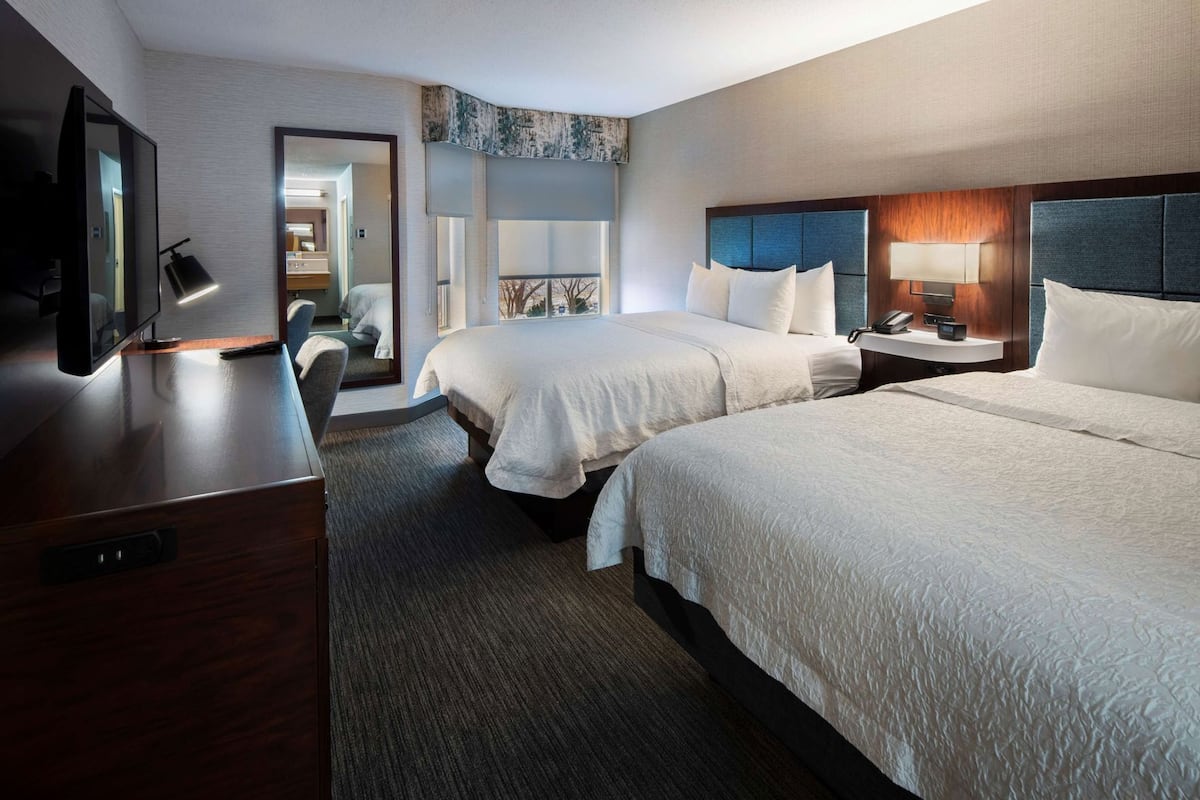 Hypo-allergenic bedding, desk, laptop workspace, blackout drapes