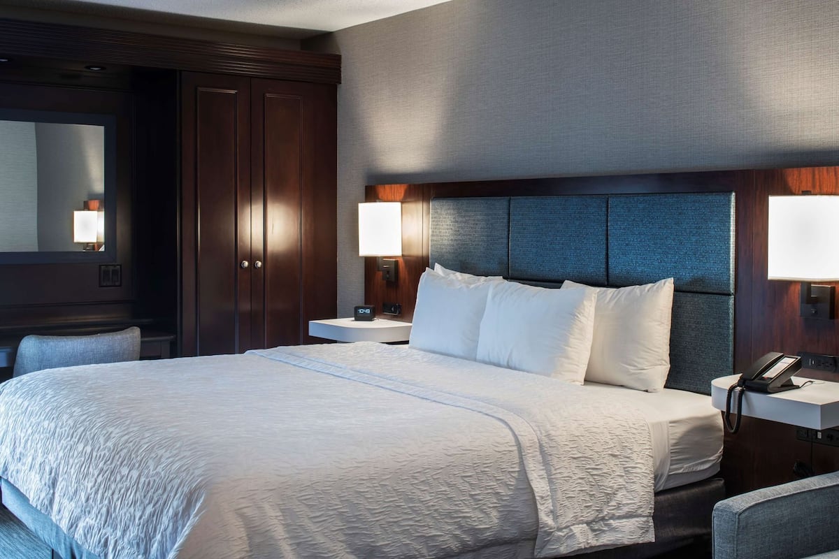 Hypo-allergenic bedding, desk, laptop workspace, blackout drapes