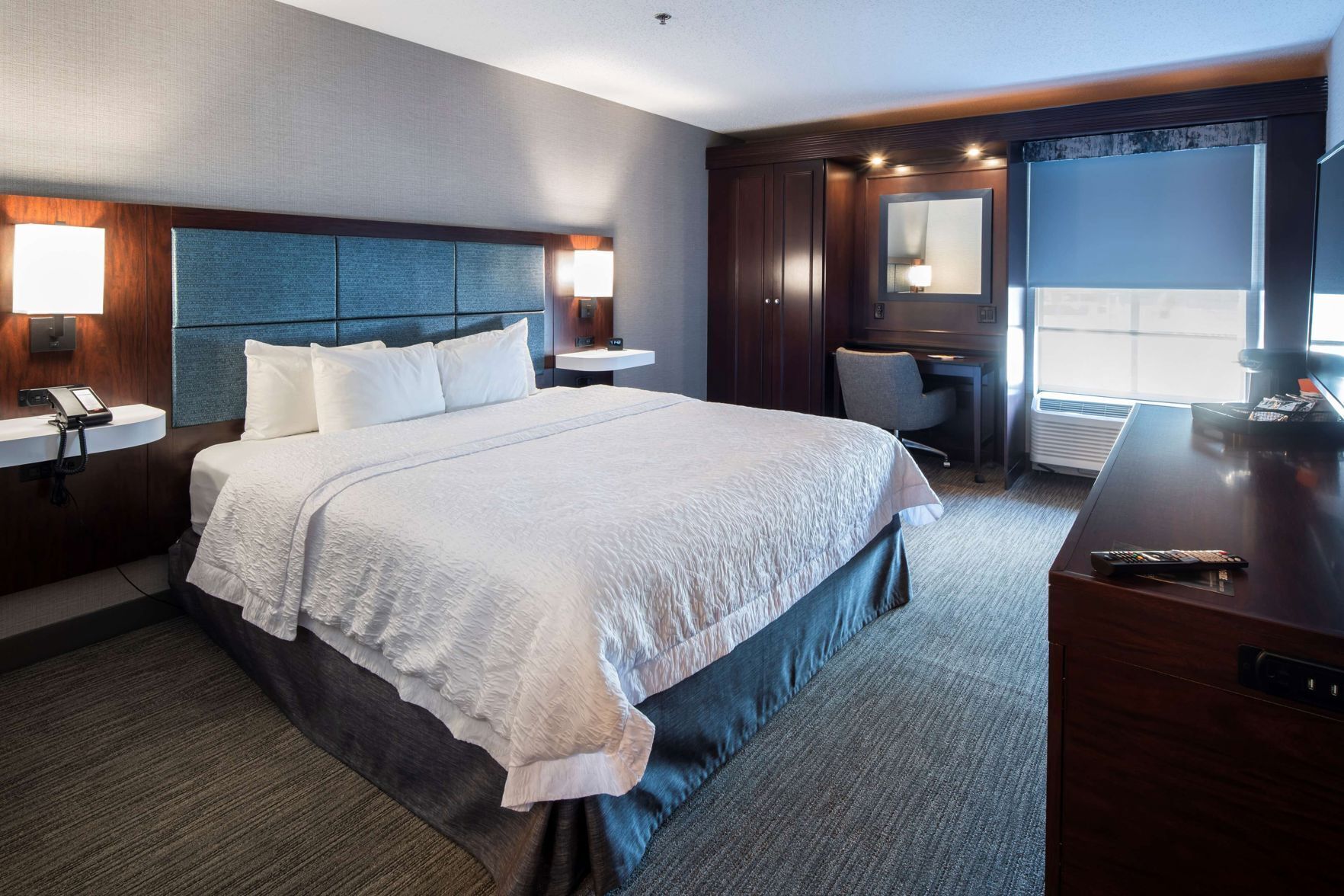 Hypo-allergenic bedding, desk, laptop workspace, blackout curtains