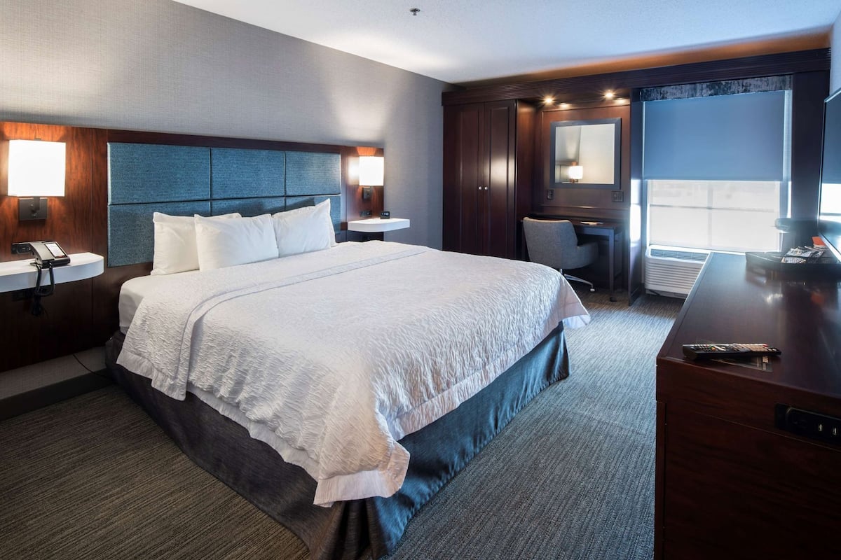 Hypo-allergenic bedding, desk, laptop workspace, blackout drapes