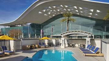 Outdoor pool, open 7:00 AM to 11:00 PM, pool loungers