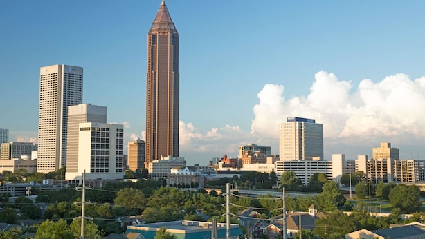 A cityscape with a prominent tall building in the center, surrounded by other high-rise buildings. - Travelodge by Wyndham Forest Park Atlanta South (Forest Park)