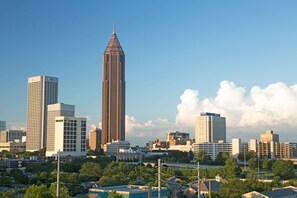 A cityscape with a prominent tall building in the center, surrounded by other high-rise buildings. - Travelodge by Wyndham Forest Park Atlanta South (Forest Park)