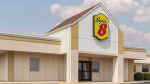 A Super 8 hotel with a prominent sign, a flat roof, and a simple facade.