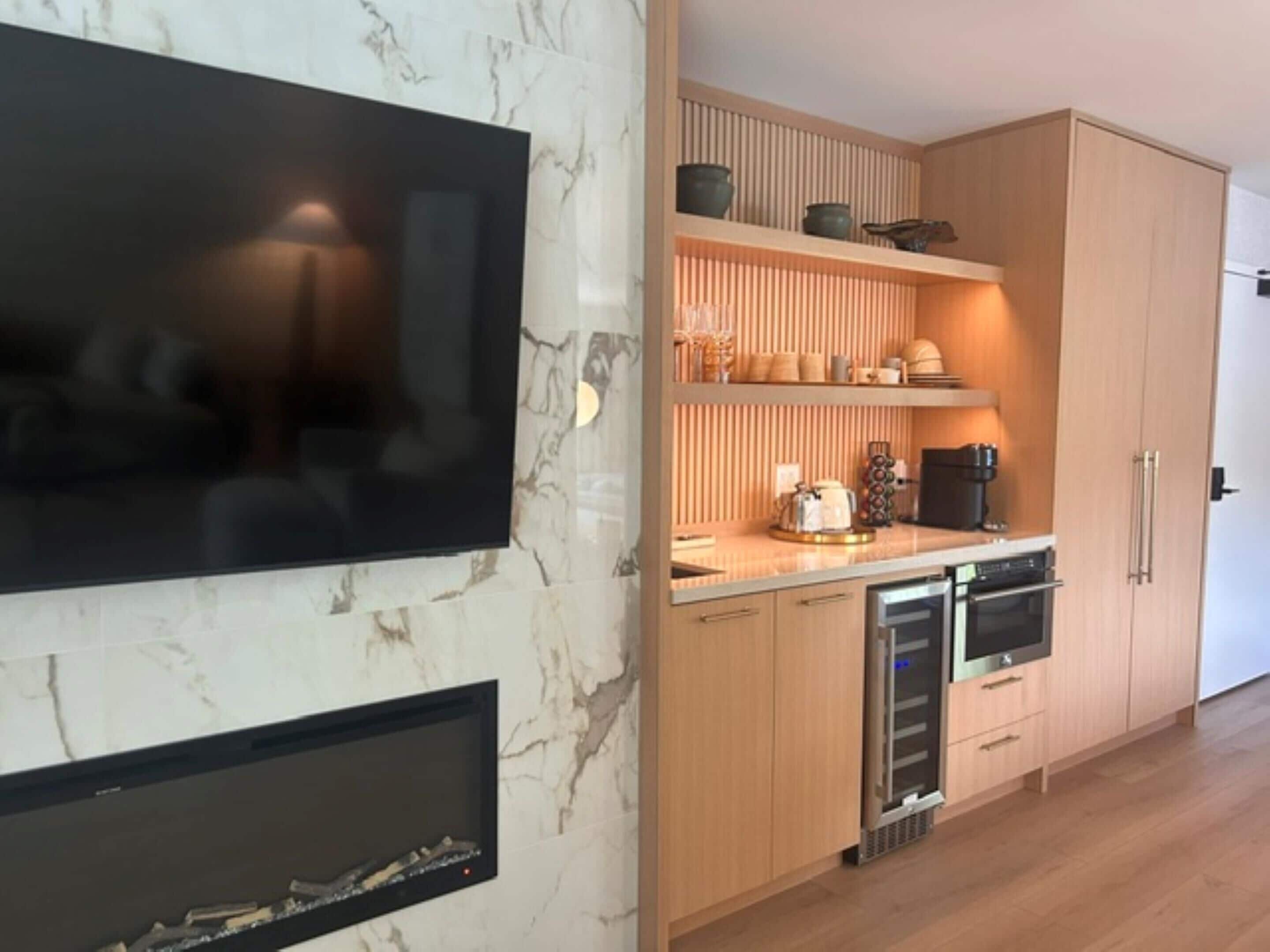 A modern kitchen with a built-in oven, a microwave, and a coffee maker on the countertop.