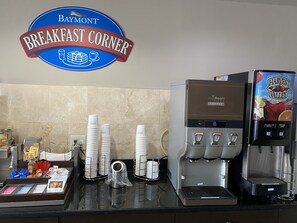 A breakfast station with a Baymont sign, a coffee machine, and a juice dispenser. - Baymont by Wyndham Milan (Milan)