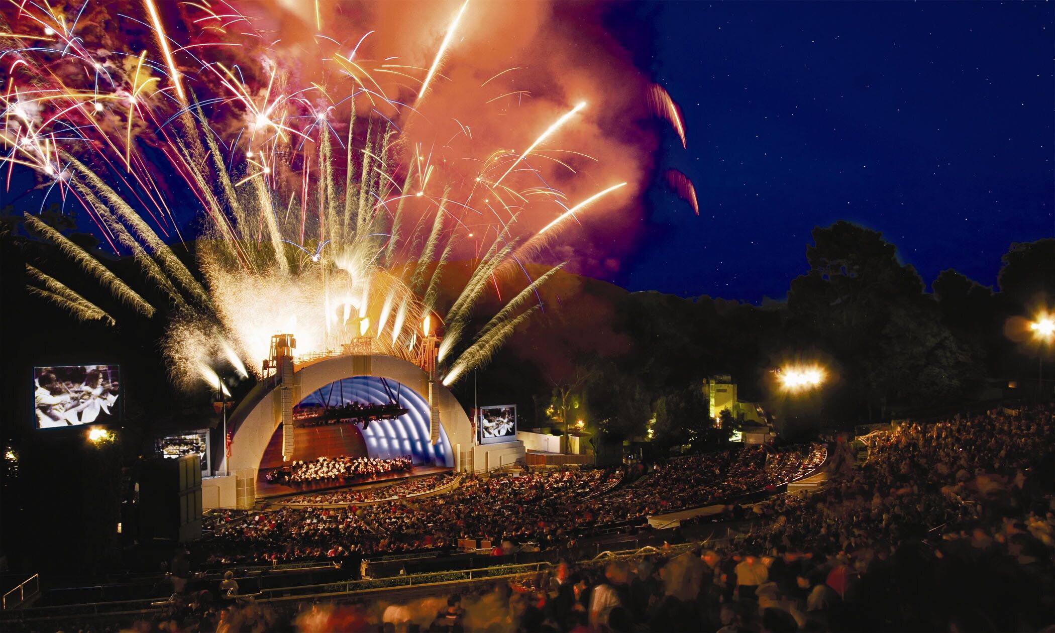A large outdoor amphitheater with a stage and audience seating.