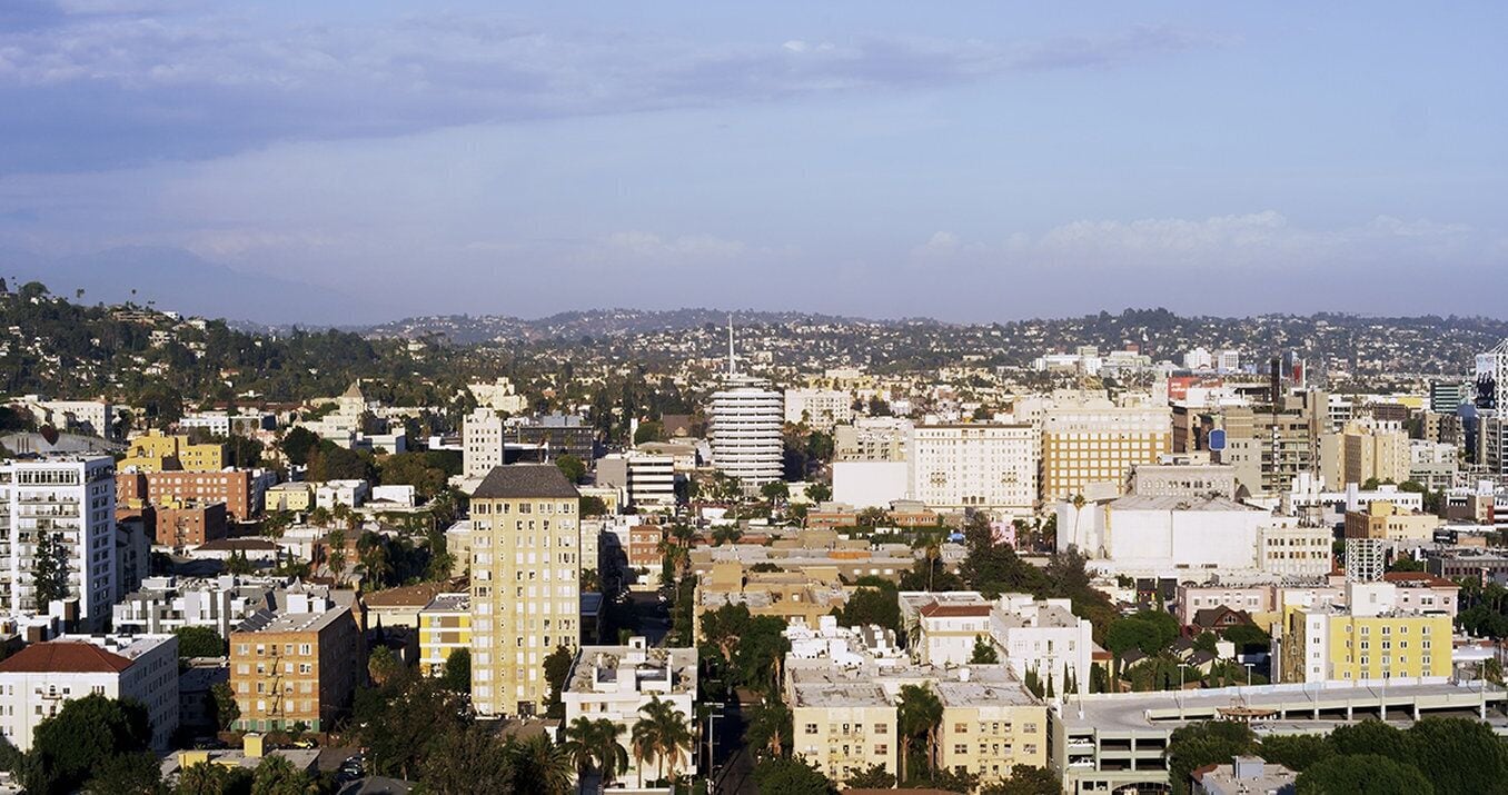 A cityscape with a variety of building types, including high-rise and mid-rise structures, and a mix of architectural styles.