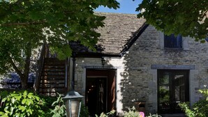 A stone building with a reception area, a wooden staircase, and a lantern. - Best Western Plus Angel Hotel (Chippenham)