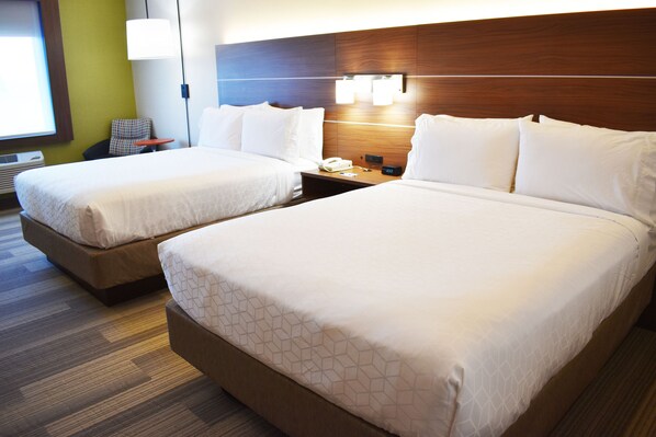 A hotel room with two beds, a nightstand, a chair, and a lamp. - Holiday Inn Express & Suites Albany by IHG (Albany)