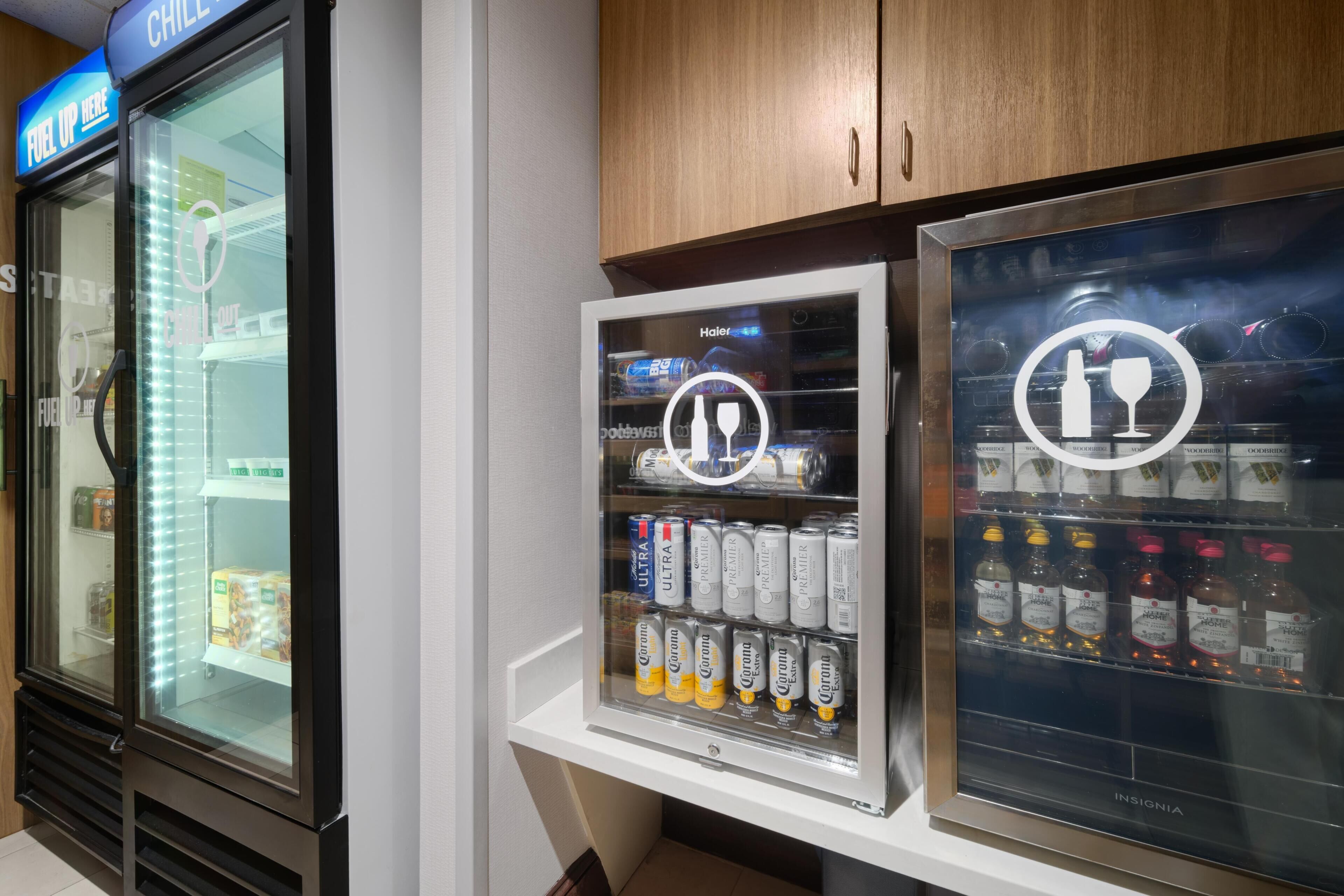 A vending machine with Corona beer cans and a refrigerator with a 'CHILL OUT' sign.