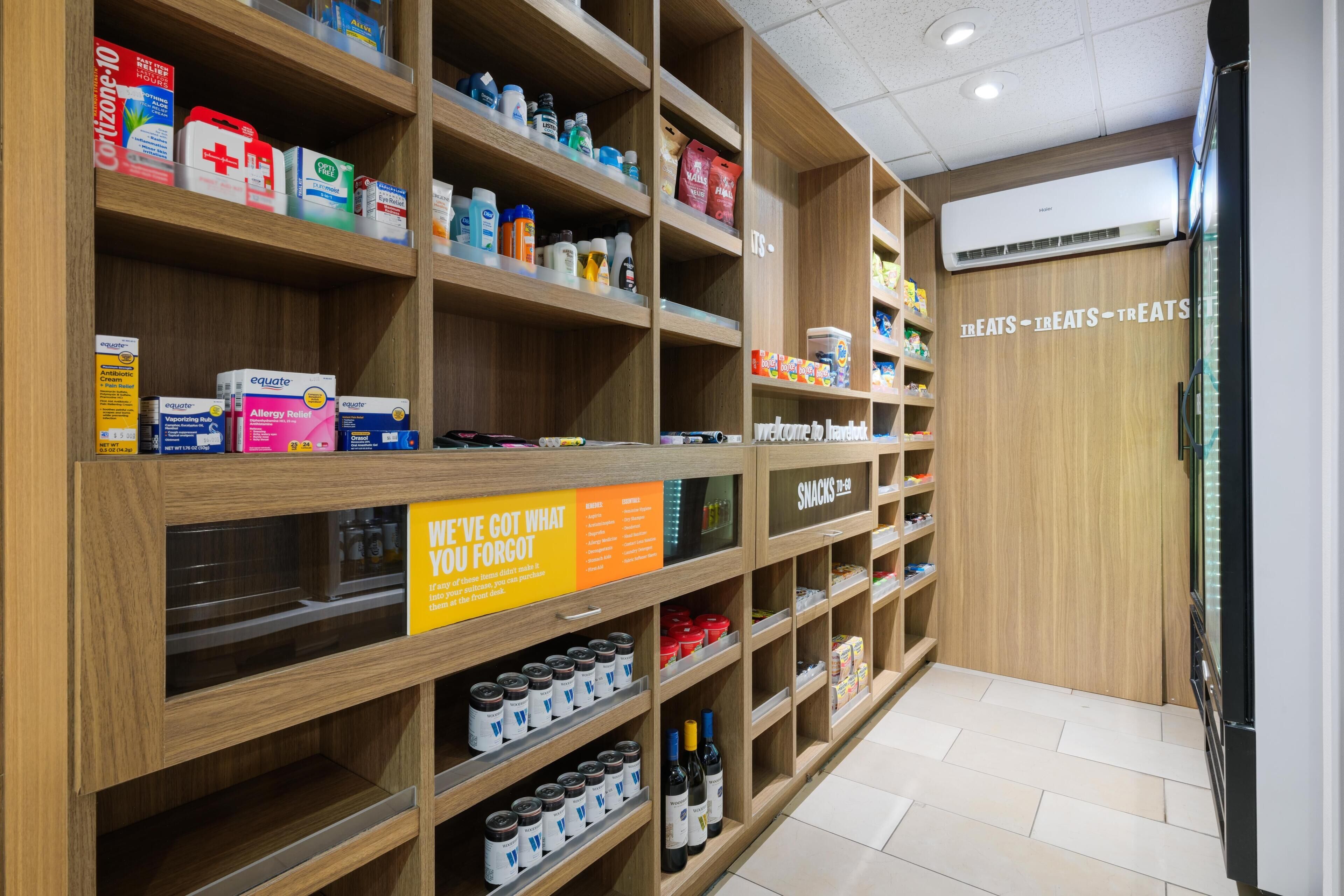A pharmacy section with shelves stocked with various health and beauty products.