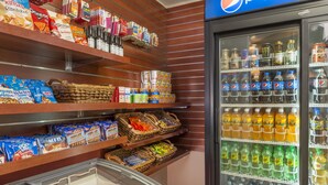 A snack and beverage display with various packaged snacks and drinks, including Pepsi. - Ayres Hotel Laguna Woods - Aliso Viejo (Laguna Woods)