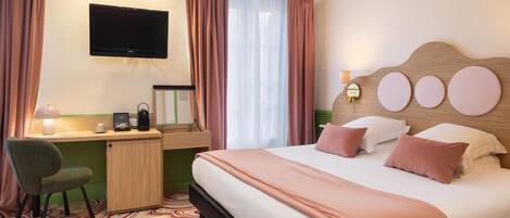 A hotel room with a bed, desk, chair, television, and a window with curtains.