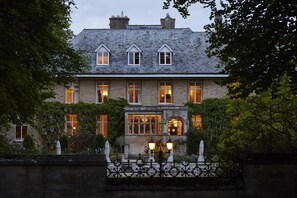 A stone building with multiple windows and a central entrance. - The Slaughters Manor House (Cheltenham)