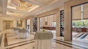 A spacious lobby with a grand chandelier, marble flooring, and a view of the outdoors. - Sheraton New Delhi Hotel (New Delhi)