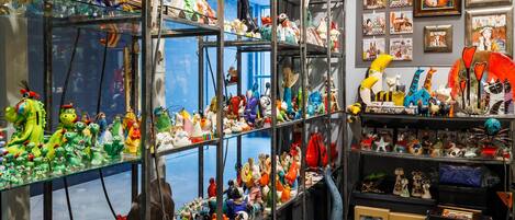 A room with multiple shelves filled with various decorative items and figurines.