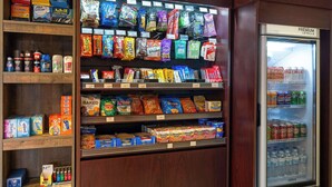 A grocery store with shelves stocked with snacks, beverages, and household items. - Ramada by Wyndham Locust Grove (Locust Grove)