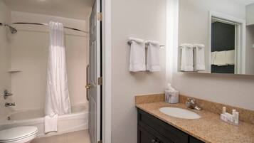 A bathroom with a bathtub, toilet, sink, and towel rack.