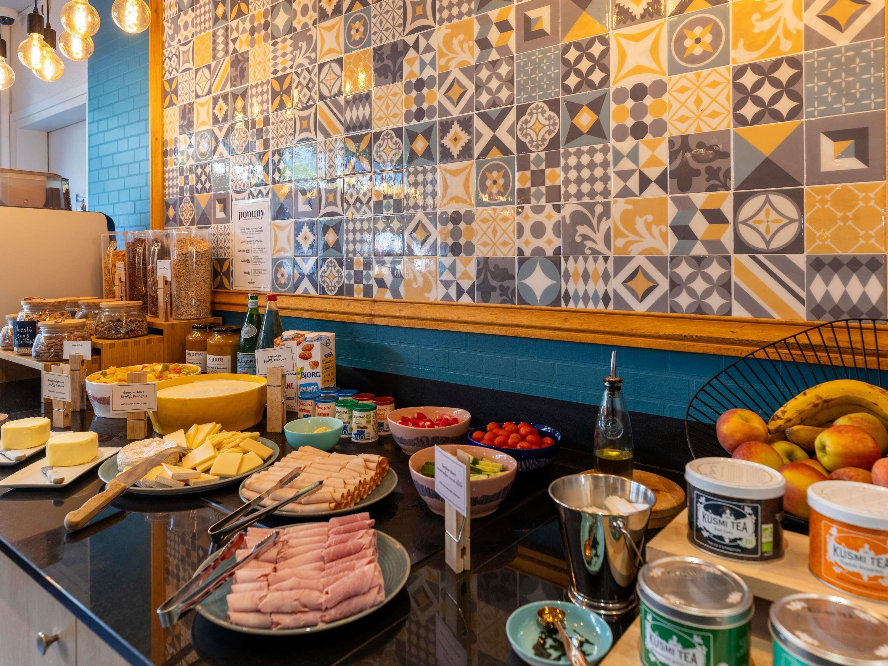 Ein reichhaltiges Buffet mit Käse, Fleisch, Obst und verschiedenen Beilagen.