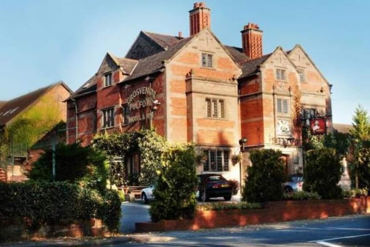 A traditional brick building with a sign reading 'Grosvenor Hotel.'