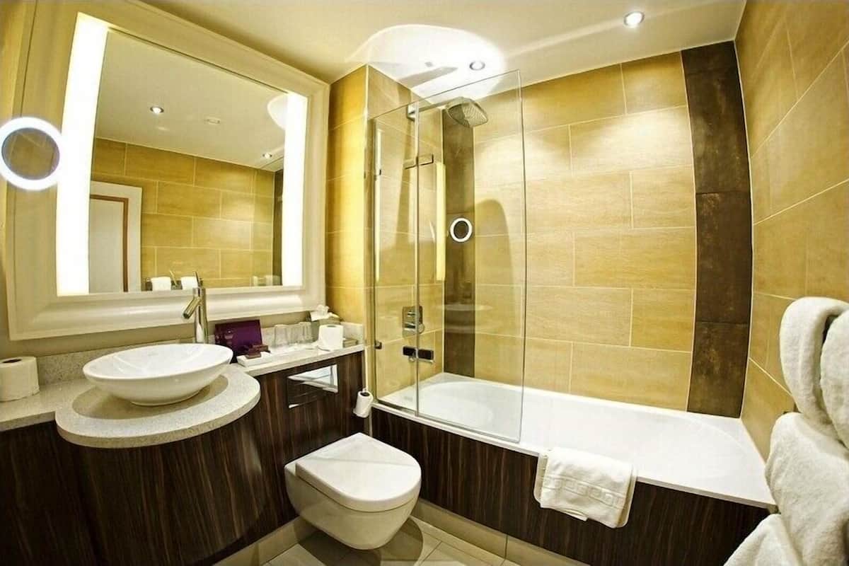 designer toiletries, hair dryer, slippers, towels