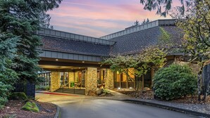 A modern building with a stone facade, large windows, and a covered entrance. - Mt Hood Oregon Resort, BW Premier Collection (Welches)