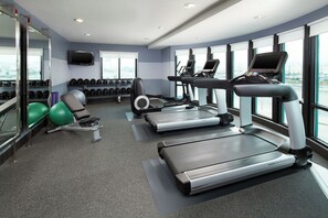 A gym with treadmills, elliptical machines, and free weights. - Four Points by Sheraton Hotel & Suites San Francisco Airport (South San Francisco)
