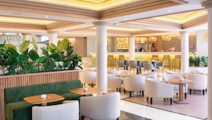 A hotel lobby with seating areas, a bar, and a reception desk. - Sol Sun Beach Apartamentos (Adeje)