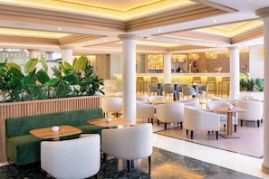 A hotel lobby with seating areas, a bar, and a reception desk. - Sol Sun Beach Apartamentos (Adeje)