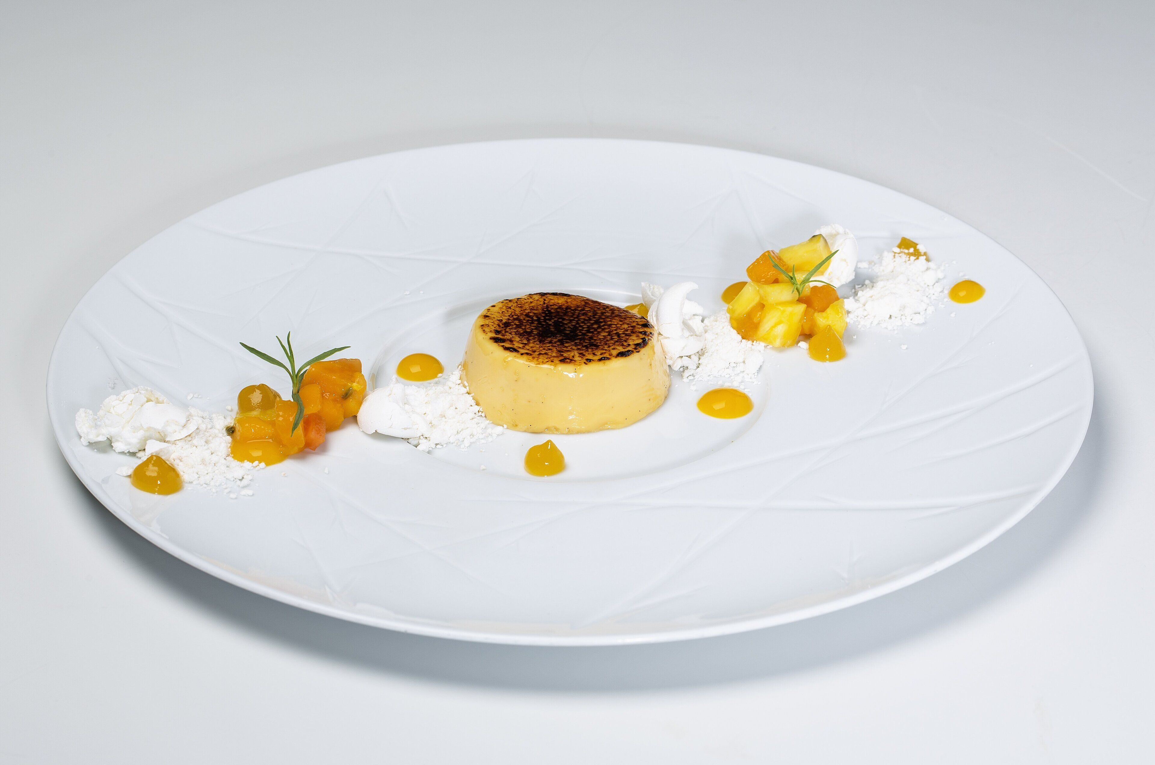 A dessert on a white plate with a textured surface.