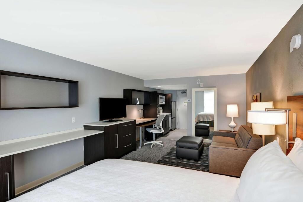 Premium bedding, desk, laptop workspace, blackout drapes