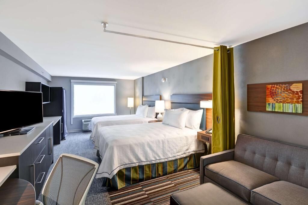 Premium bedding, desk, laptop workspace, blackout drapes