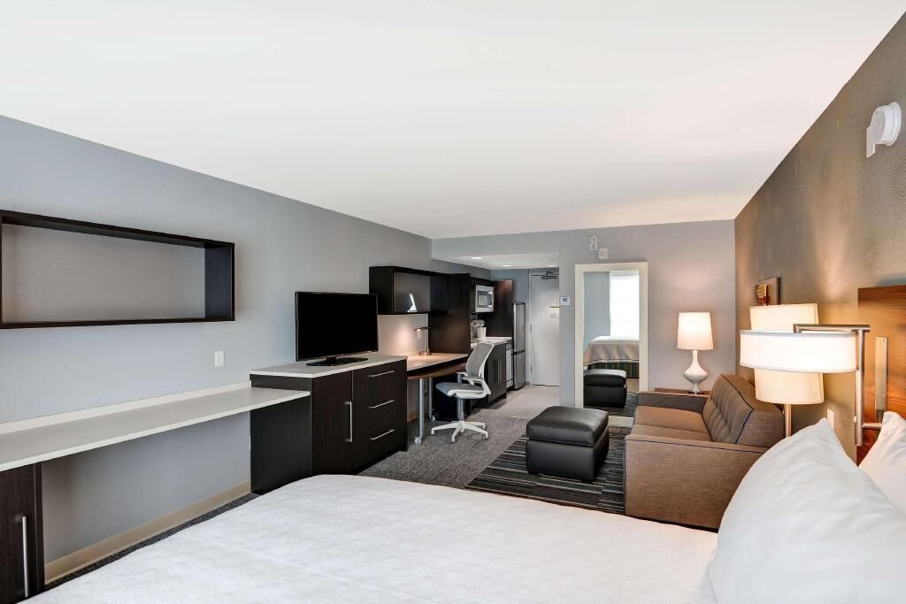 Premium bedding, desk, laptop workspace, blackout drapes