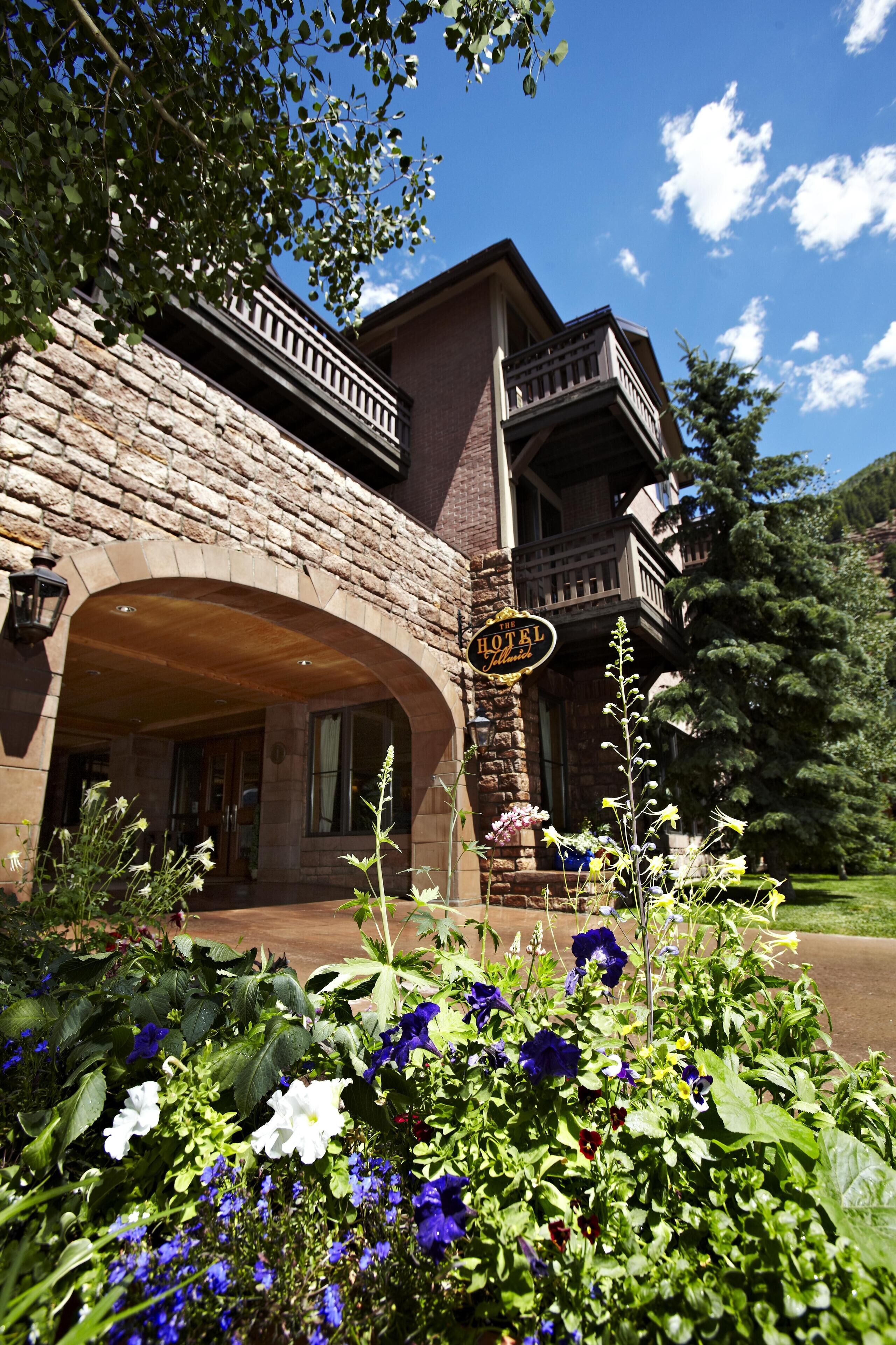 A stone building with a sign that reads "The Hotel."