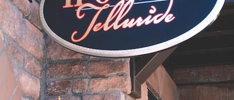 A hotel sign with the name "The Hotel Telluride" in a classic font.