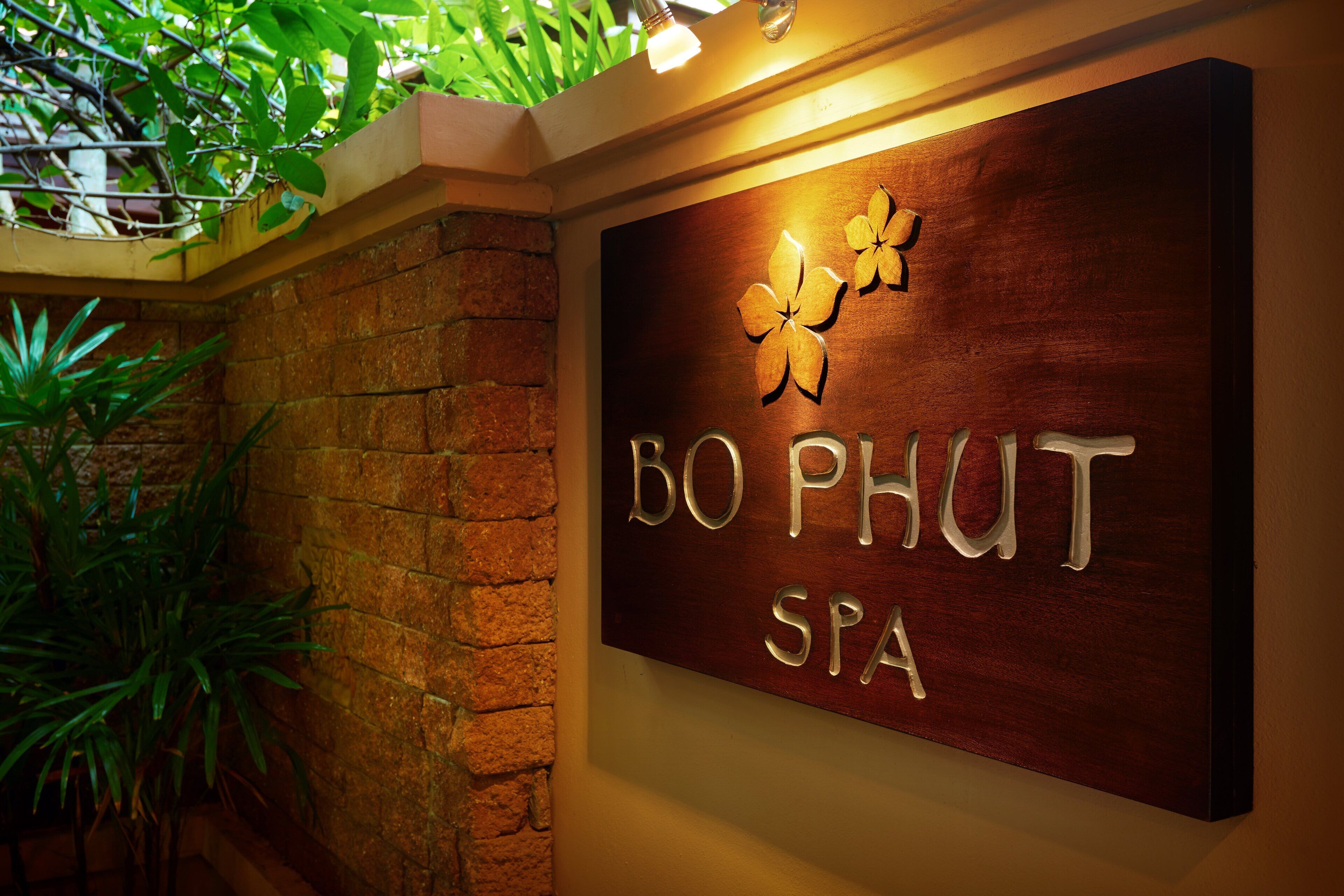 A wooden sign with the text "BO PHUT SPA" and decorative floral elements.