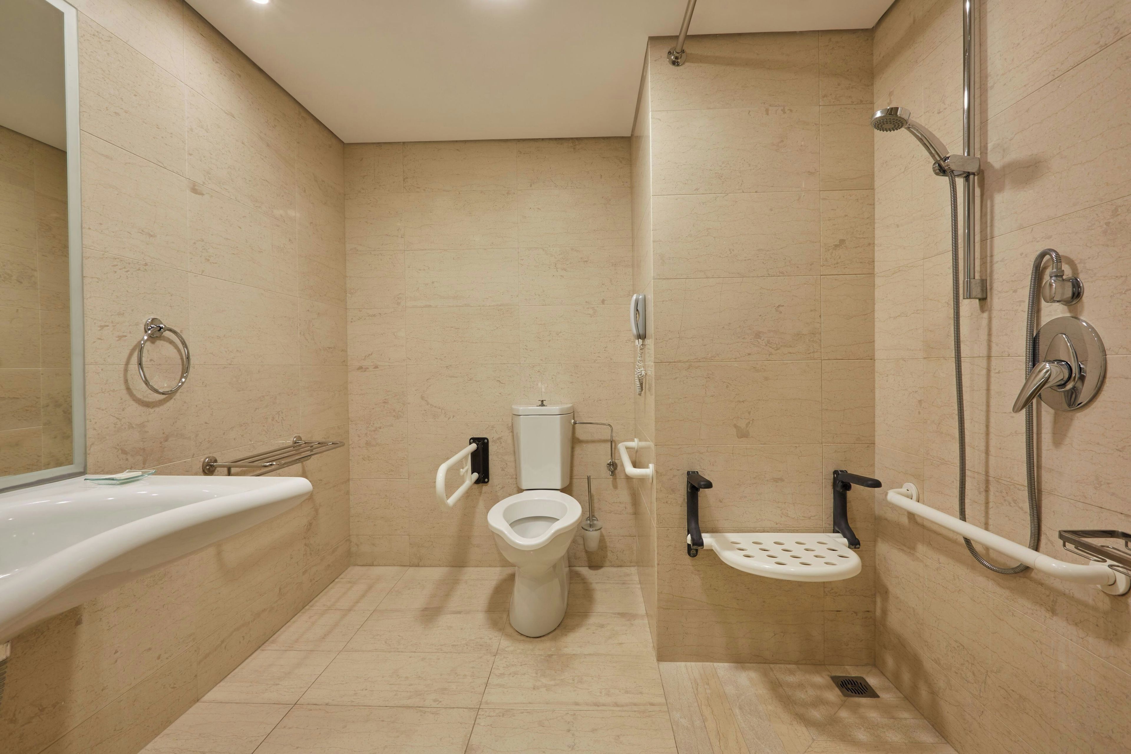 A modern bathroom with a toilet, bidet, and shower.
