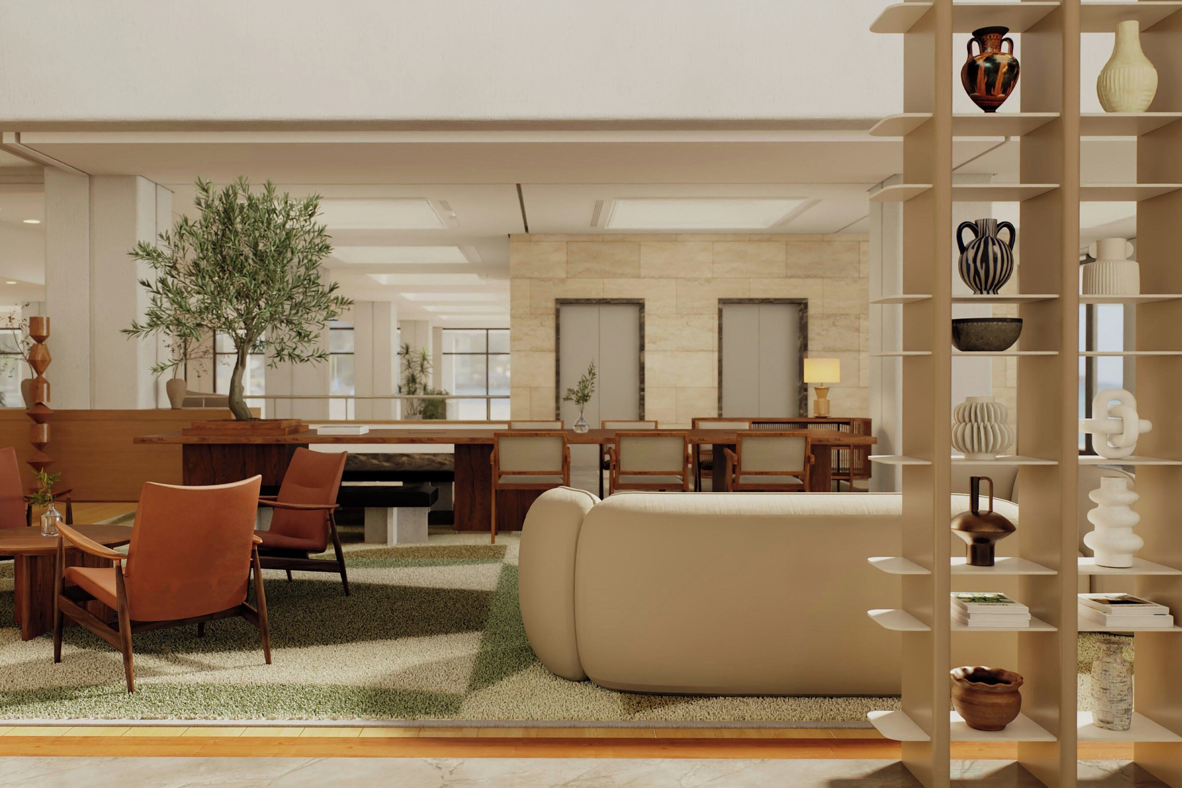 Un salon moderne comprenant un canapé, des fauteuils, une table à manger et une bibliothèque.